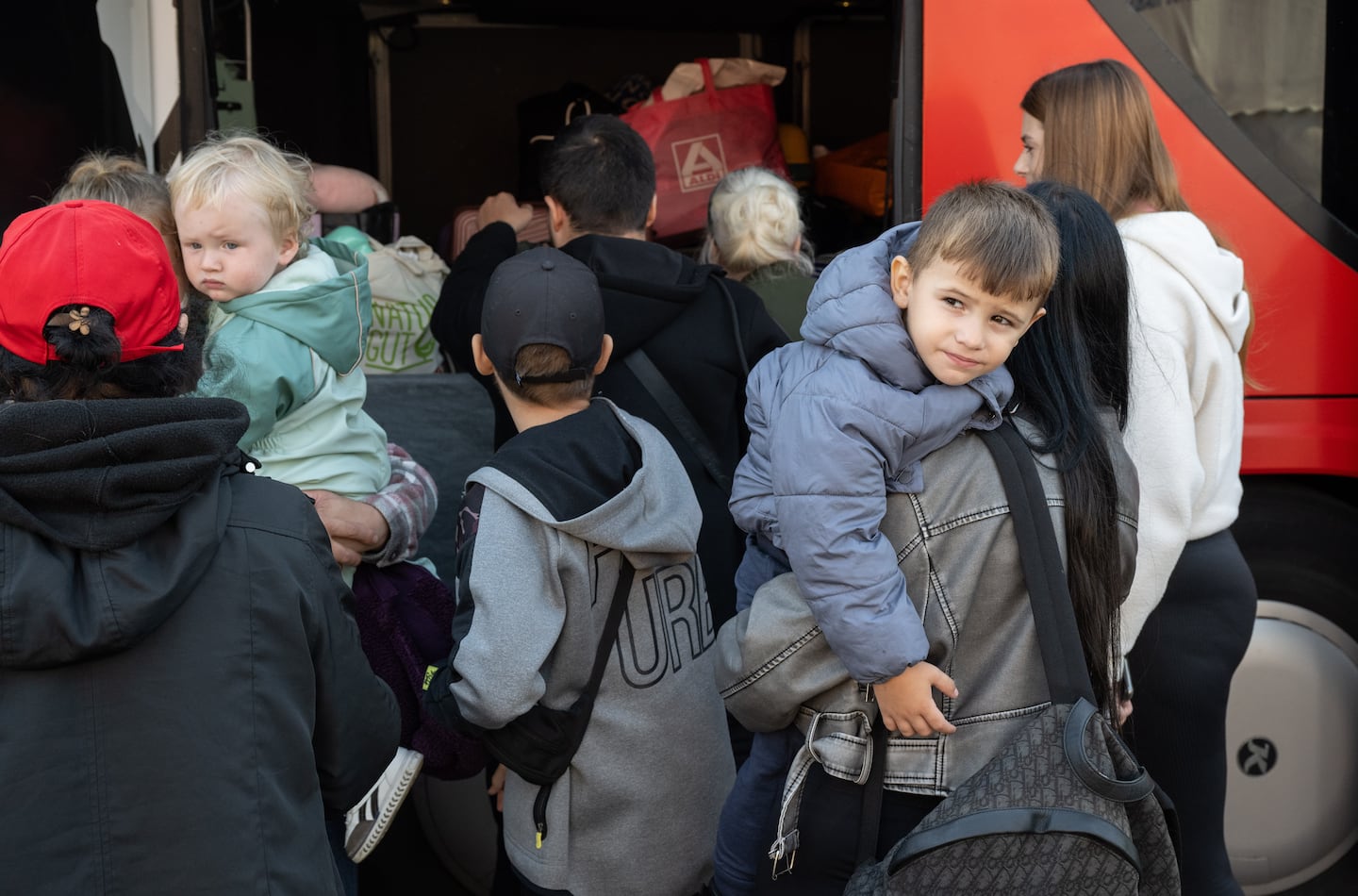 Refugees from Ukraine stood by a bus at the initial reception center for refugees in Hesse, Germany on Sept. 18. From here, the people are distributed to the municipalities within the state.