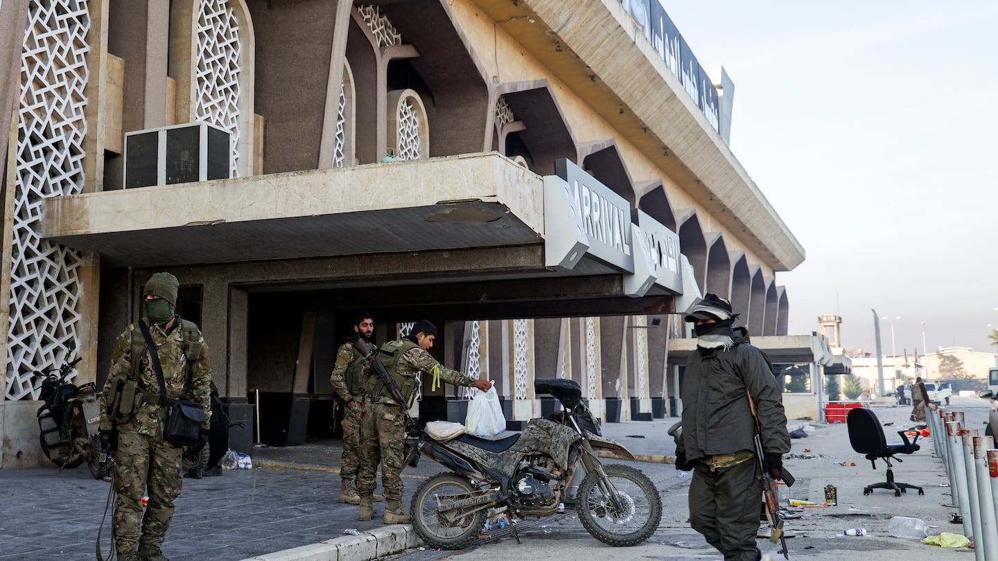 Syrian opposition fighters at the arrivals gate of the Aleppo international airpot in Aleppo, Syria, on Dec. 2.