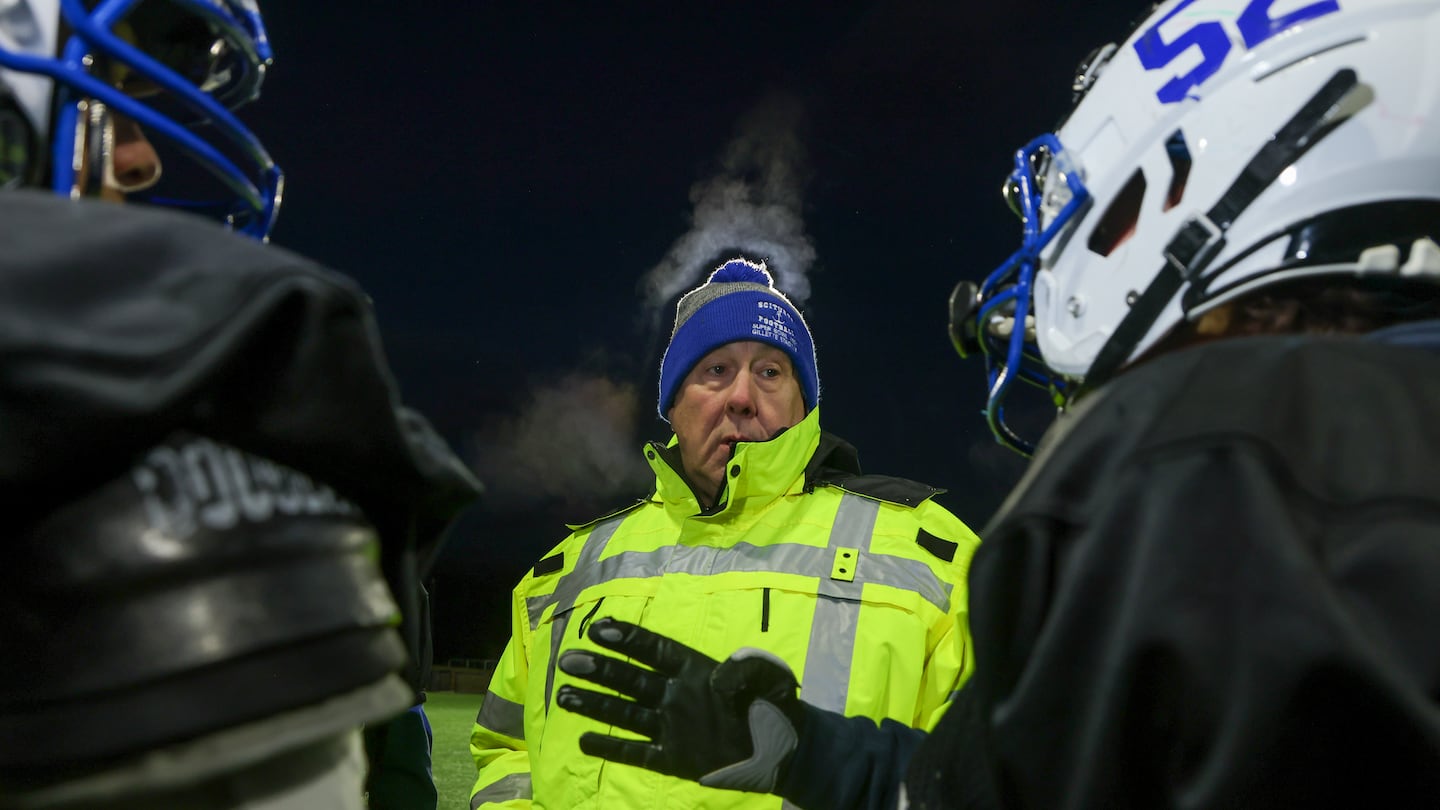 Scituate High offensive line coach Kevin Regan has a discussion with his charges during Monday's chilly practice before their Division 4 Super Bowl game against Duxbury Thursday at Gillette Stadium.     

     
