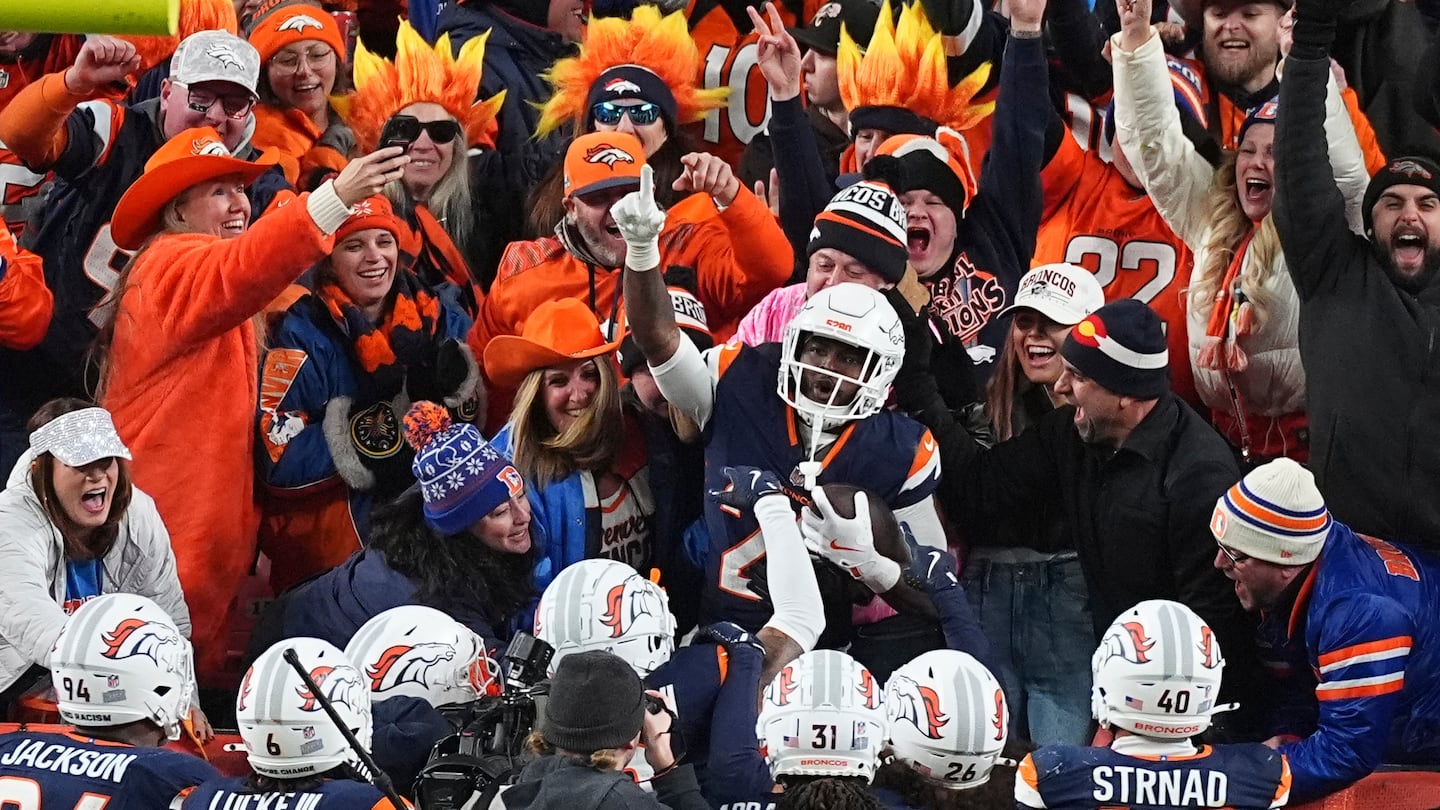 Broncos cornerback Ja'Quan McMillian celebrates with fans after returning an interception for a touchdown in the late stages of Monday's win over Cleveland.