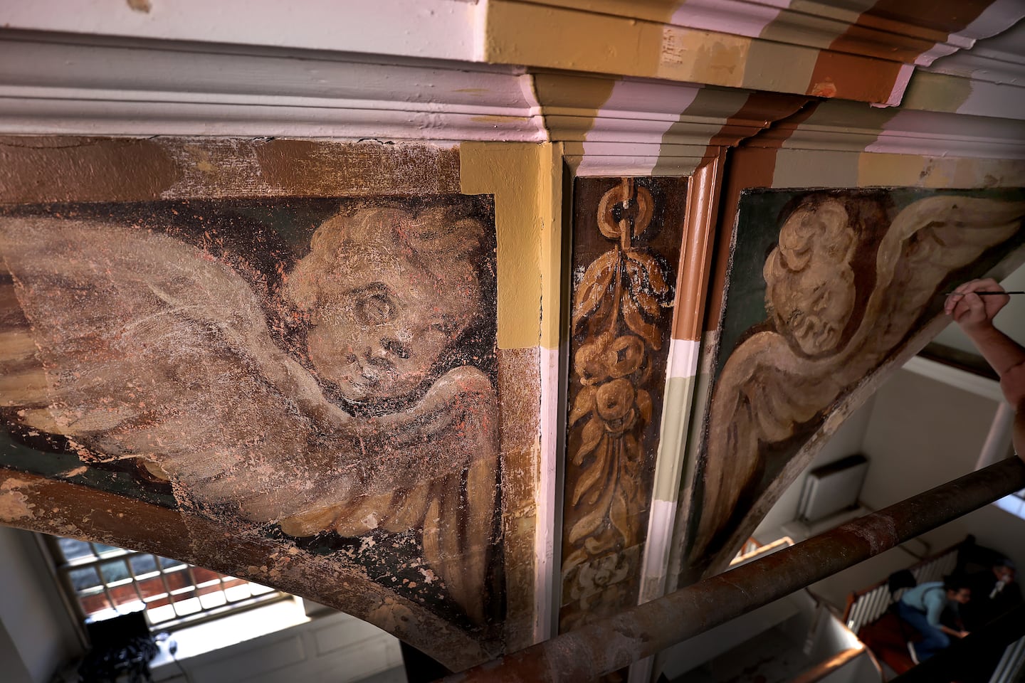 From left: the first angel that was uncovered in 2017, nicknamed "Howard," and an angel in the process of being restored by a conservator.