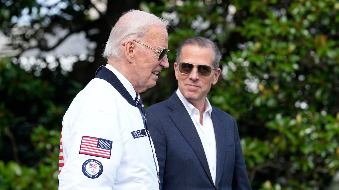 President Biden, wearing a Team USA jacket and walking with his son Hunter, headed toward Marine One on the South Lawn of the White House in Washington on July 26.