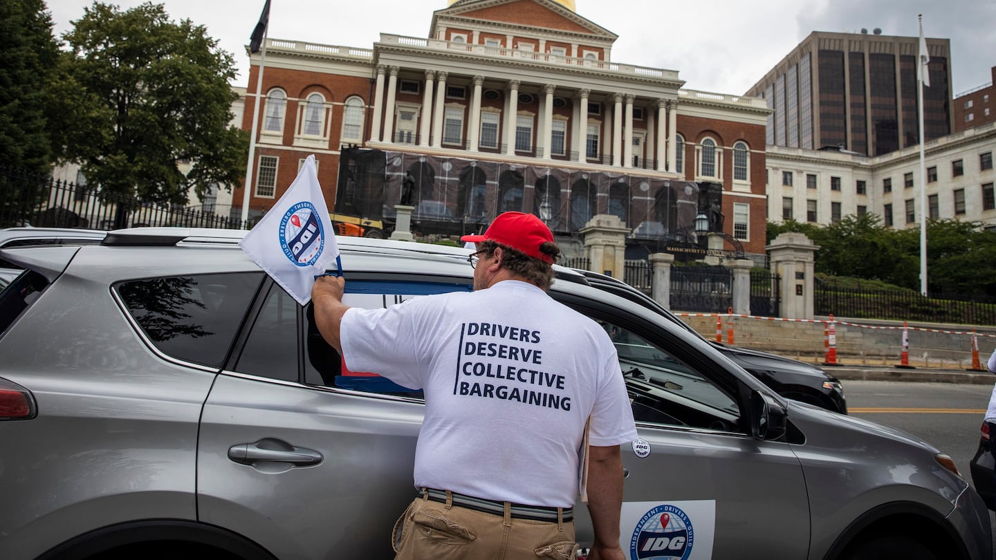 Kevin Murphy, a delivery driver for multiple apps, parks in front of the State House during a demonstration in 2022.