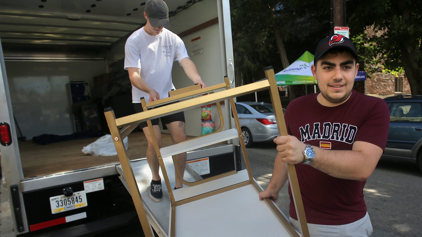 Alex Harte, right, and Justin Diraddo unload a U-Haul in Allston on Sept. 1, 2022.