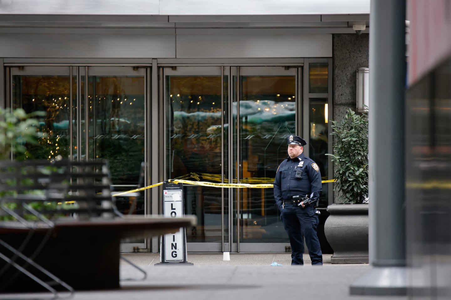 A New York police officer stood outside the Hilton Hotel in midtown Manhattan where Brian Thompson, the CEO of UnitedHealthcare, was fatally shot, on Wednesday in New York City.