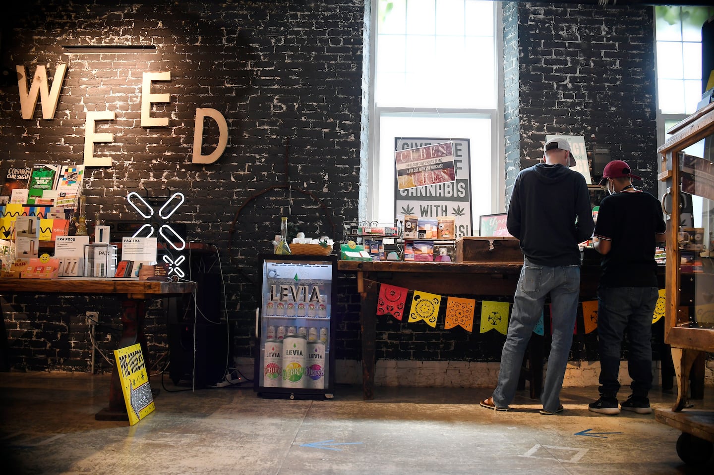 A sales associate helps a customer at Canna Provisions in Holyoke in 2021.