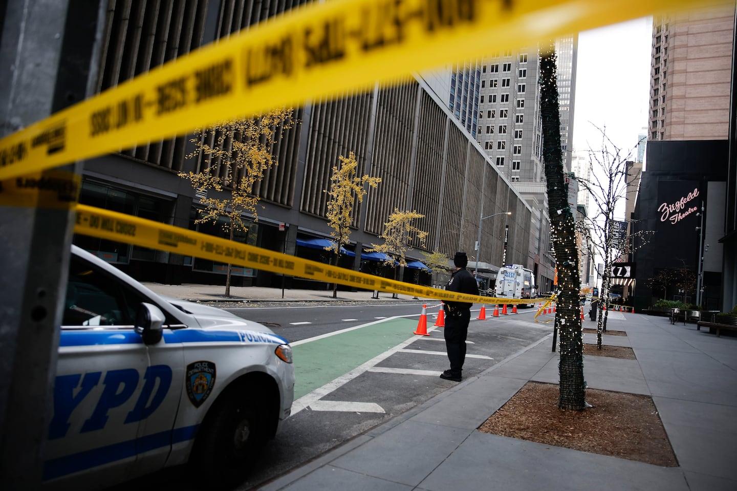 A New York police officer stands on 54th Street outside the Hilton Hotel in midtown Manhattan where Brian Thompson, the CEO of UnitedHealthcare, was fatally shot, Dec. 4, in New York.