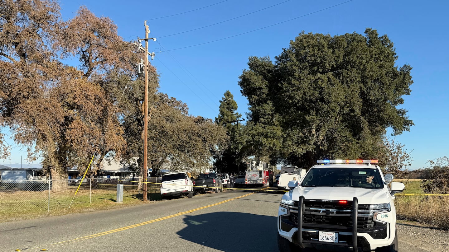 Police tape blocks a road outside the Feather River Adventist School after a shooting, Dec. 4, in Oroville, Calif.