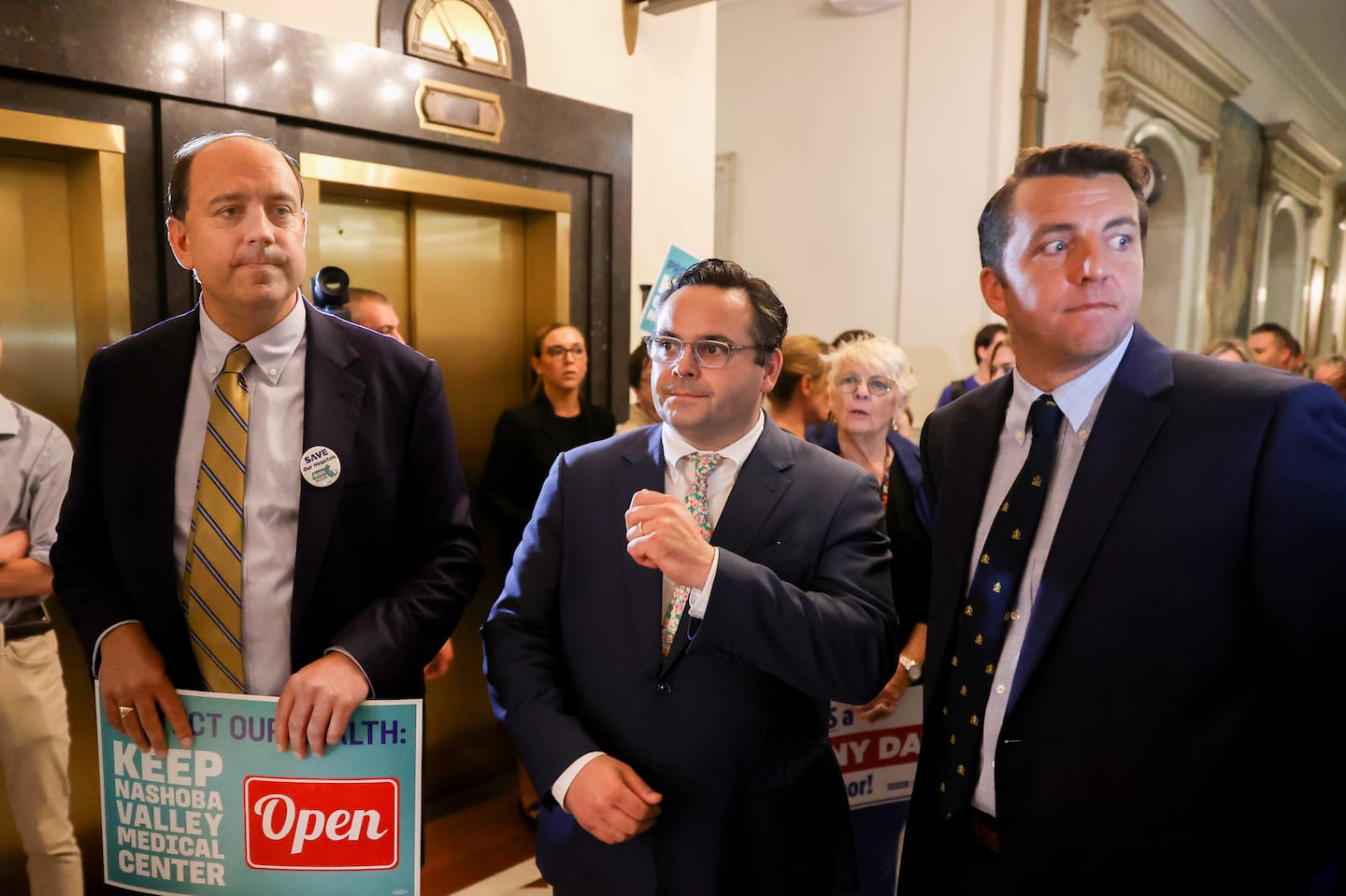 State Senator Nick Collins, center,  moved to delay a key vote on Boston Mayor Michelle Wu's effort to increase commercial property tax rates in the city.