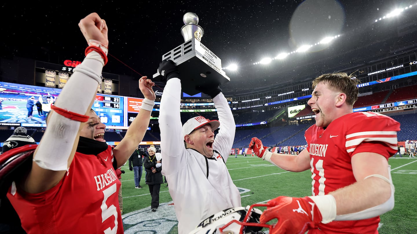 Hudson head coach Zac Attaway (center) celebrates the program's first state title in 33 years with Owen Nanartowich (left) and Garrett Giorgio.