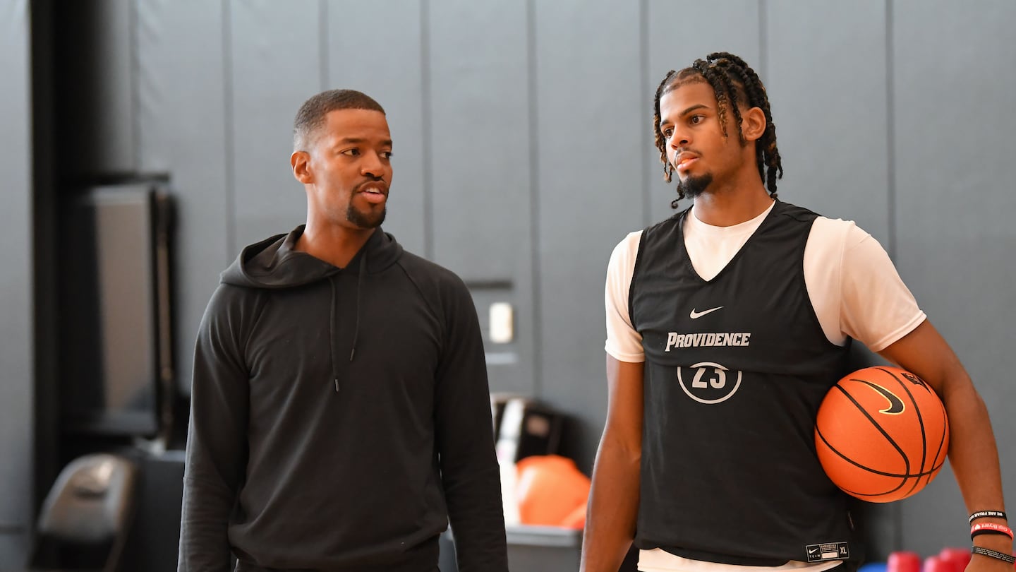 Providence College men's basketball coach Kim English, left, with forward Bryce Hopkins. The Friars’ hopes this season hinge in large part on Hopkins, who returned from a knee injury Tuesday to score 16 points against BYU.