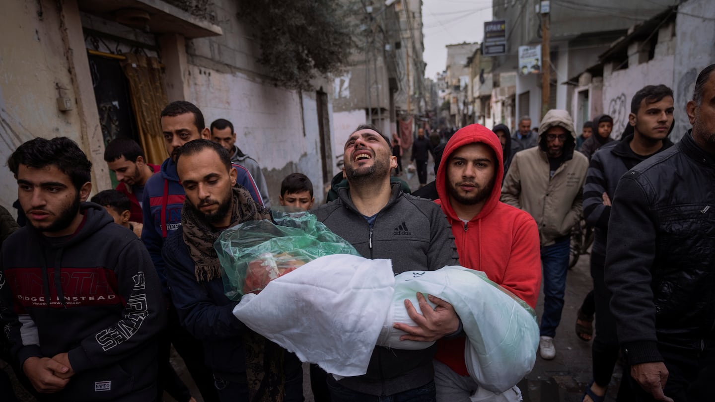 Mohammad Shouman carried the body of his daughter, Masa, who was killed in an Israeli bombardment of the Gaza Strip, during her funeral in Rafah, southern Gaza, on Jan. 17.