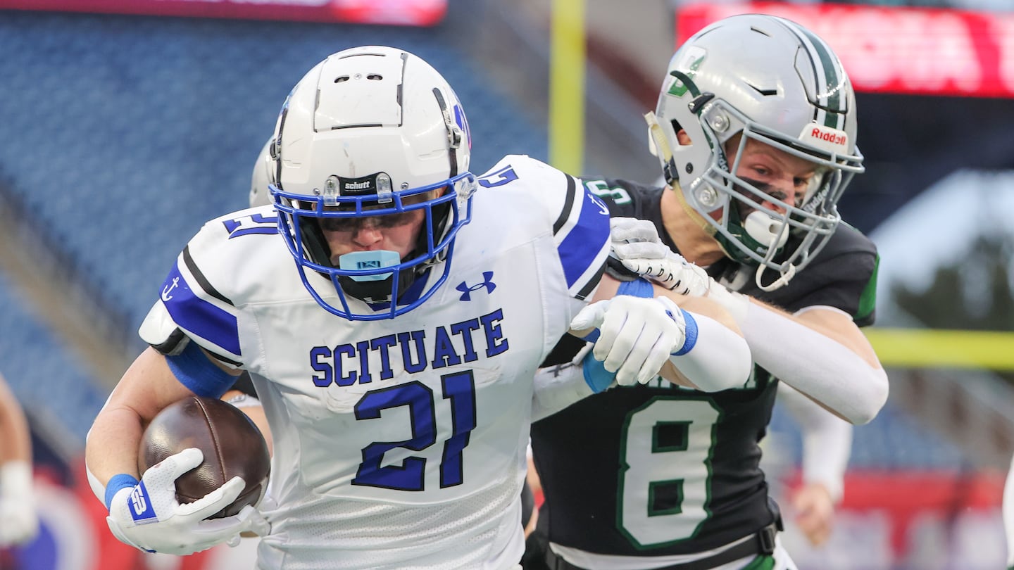 Scituate's Willy Robinson (21) is forced out of bounds by Duxbury's Jack Sovik (8) after a first-down catch.