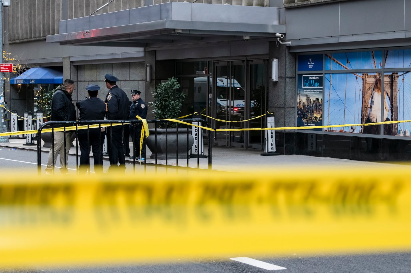 Investigators outside the New York Hilton Midtown, where Brian Thompson, the chief executive of UnitedHealthcare, was fatally shot in what police called a brazen, assassination-style slaying, on Wednesday, Dec. 4, 2024.