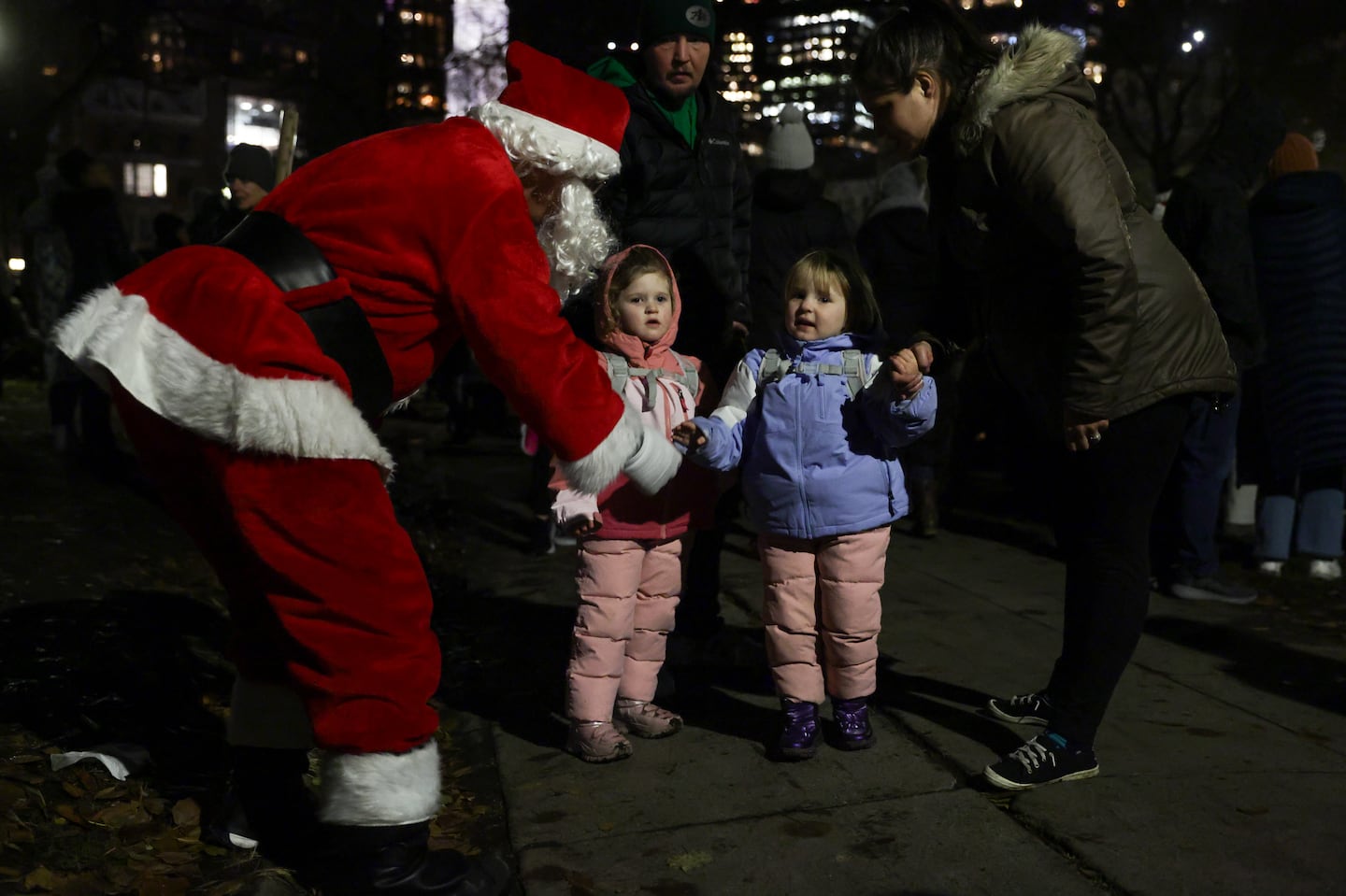 Tim Niles dressed as Santa asked Parker Swift, 4, and Miley Swift,, 3, what they want for Christmas during the 83rd annual Boston Common Tree Lighting ceremony.