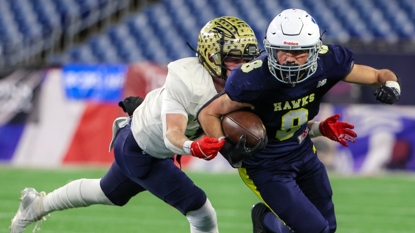 Xaverian senior Vincent Busa (8) avoids Needham's Ben Schreiber (11) in the first half of the Division 1 Super Bowl.