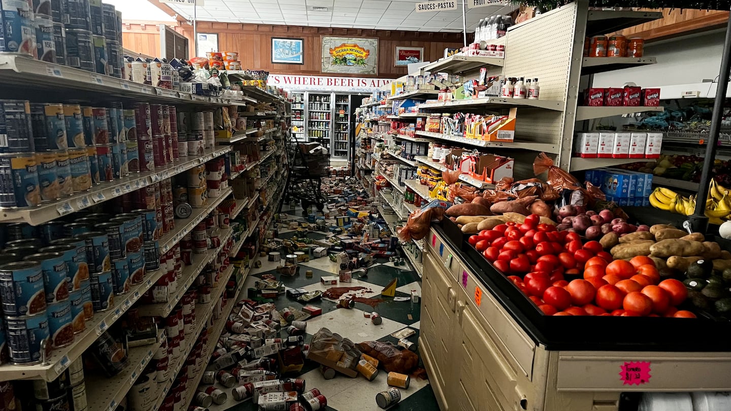 Drinks and other food items are toppled on the floor inside Hoby's Market and Deli after a 7.0 magnitude earthquake, Dec. 5, in Scotia, Calif.