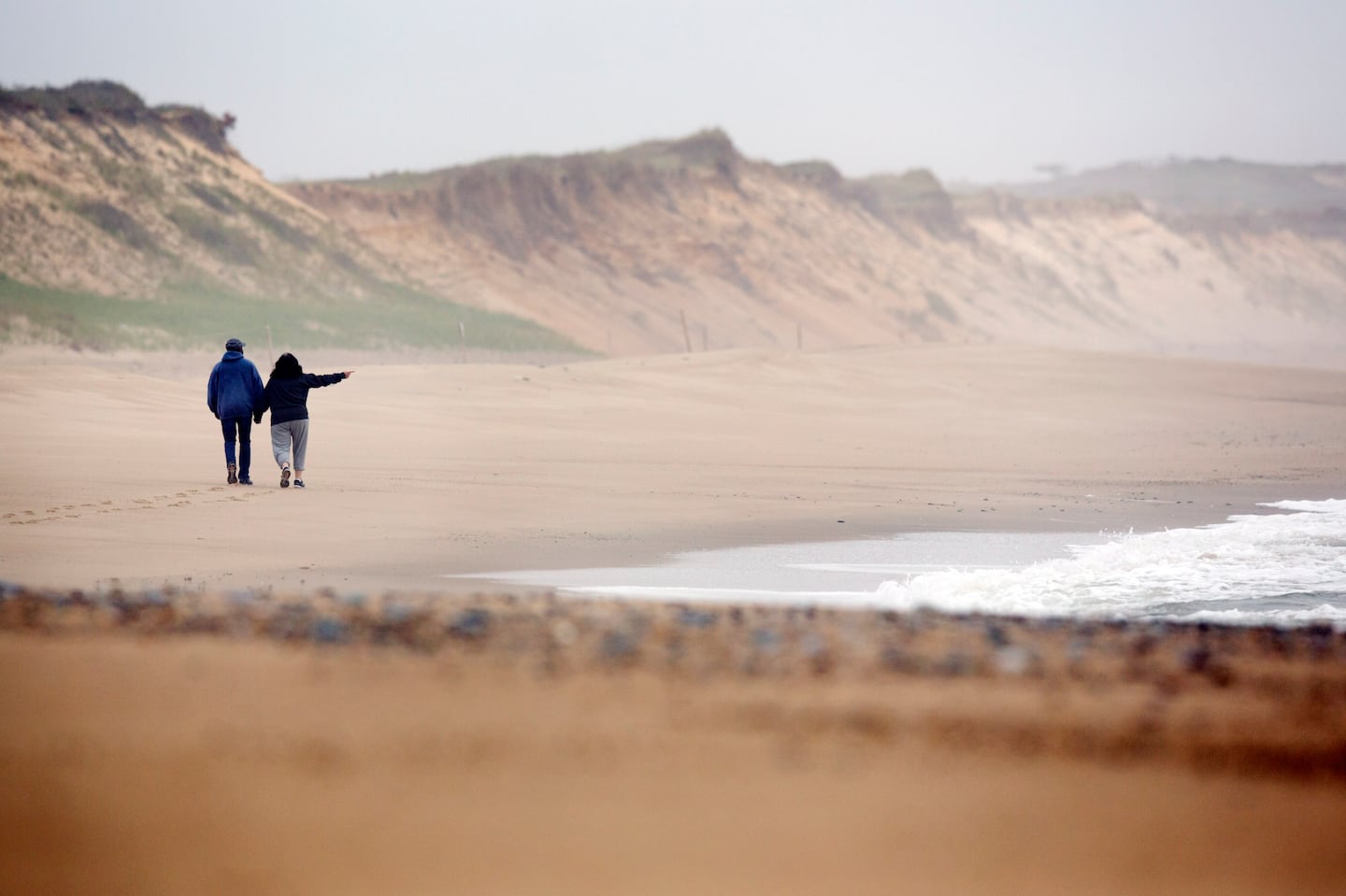 A couple takes a romantic walk on Marconi Beach in 2020. Now the beach needs a new staircase for patron access, and a group's trying to raise $125,000.