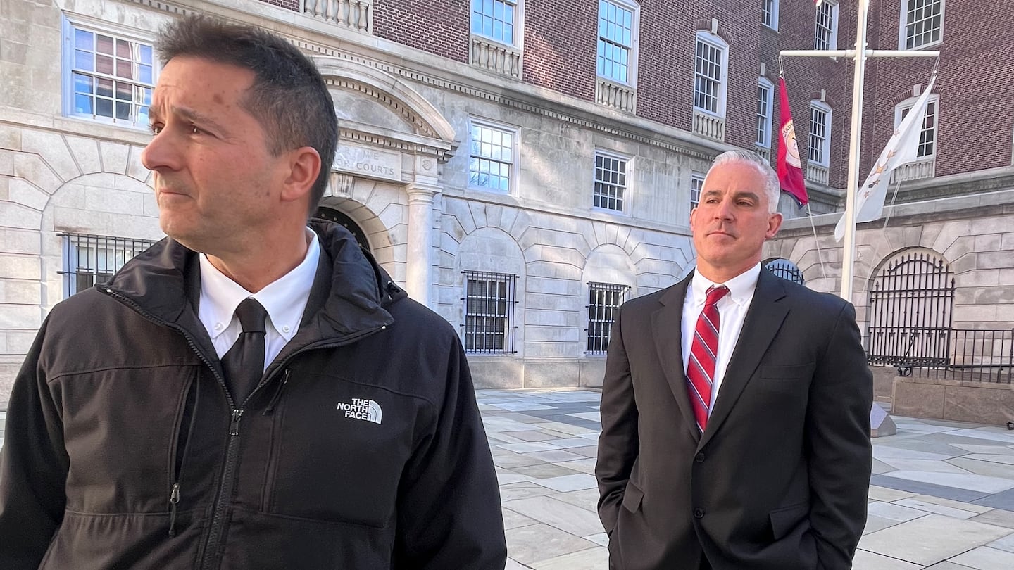 Providence police Sergeant Joseph Hanley III, right, and his lawyer, Michael J. Colucci, speak Friday outside Providence County Superior Court.