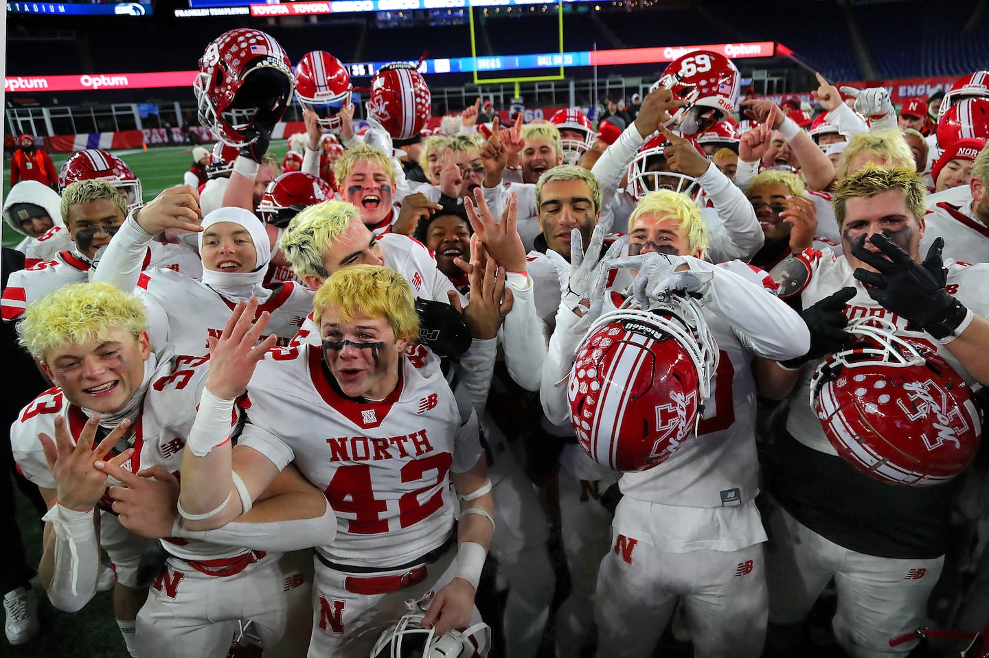 North Attleborough players celebrate at the end of their Super Bowl win by pointing to their fingers where the championship rings will go.