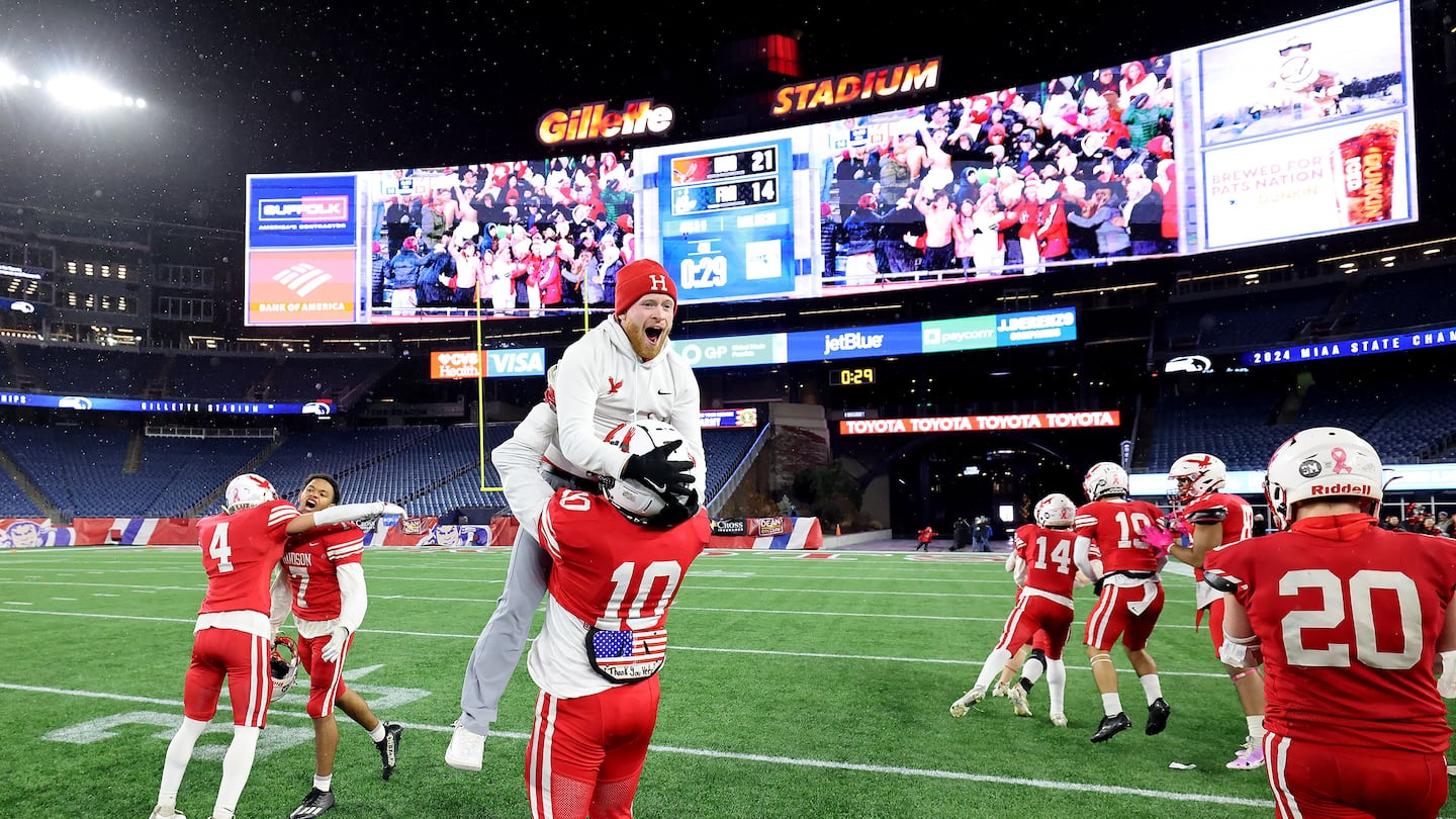 With 29 seconds still on the game clock Adrian Jacobsen (10) celebrates Hudson's state championship victory at Gillette Stadium.