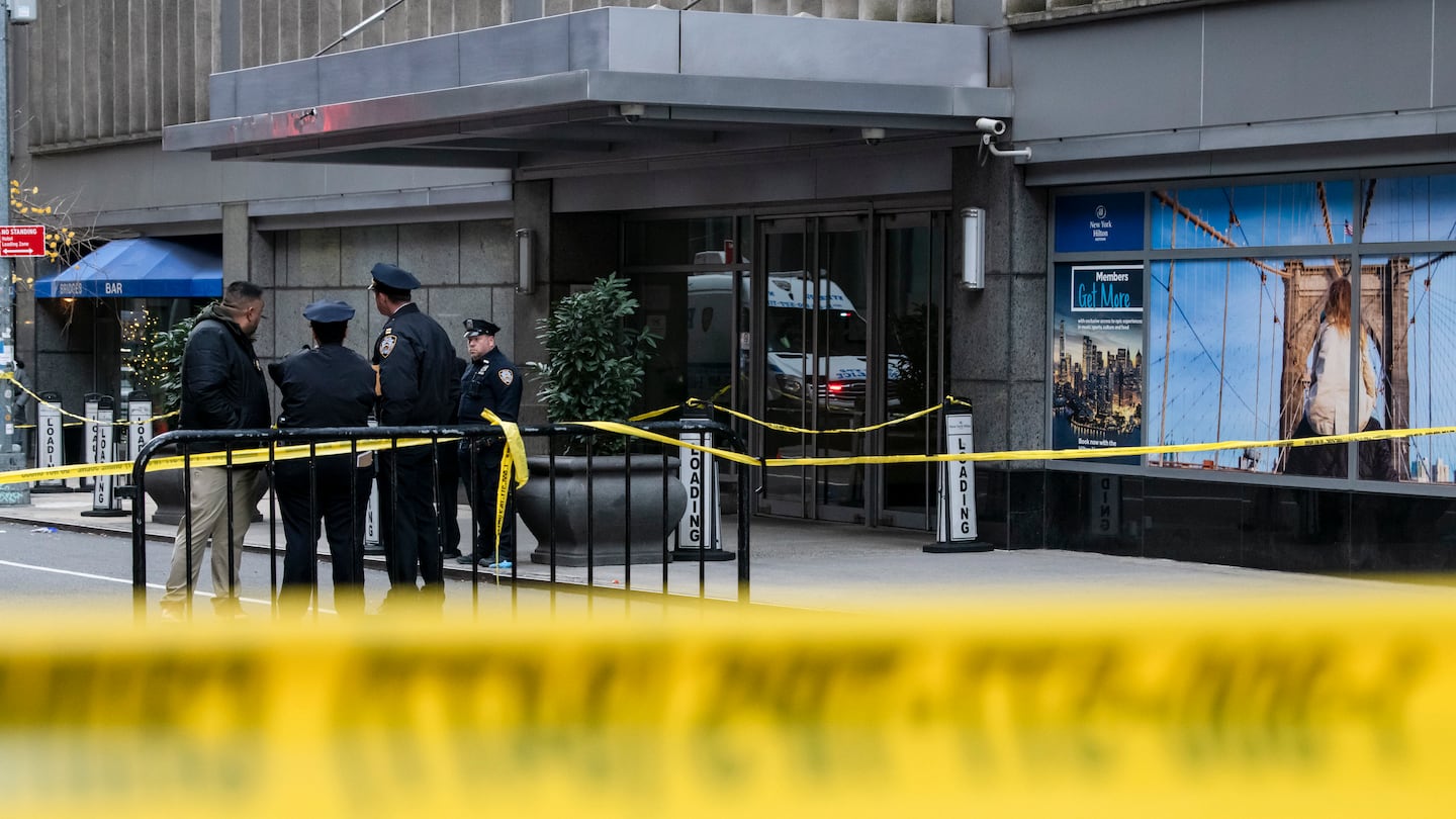 Investigators outside the New York Hilton Midtown, where Brian Thompson, the chief executive of UnitedHealthcare, was fatally shot in what police called a brazen, assassination-style slaying, on Dec. 4.