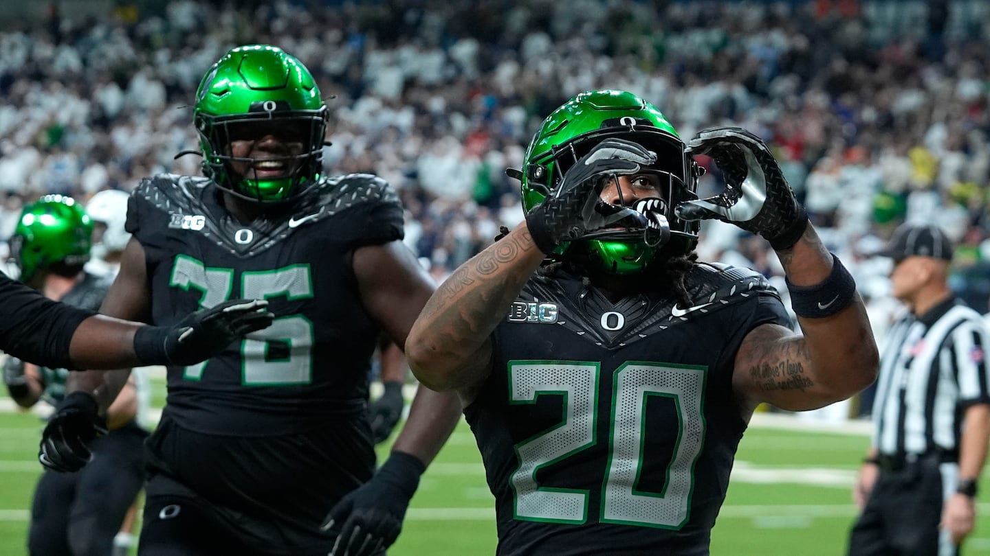 Oregon running back Jordan James (20) celebrates after scoring a 3-yard touchdown run in the fourth quarter of the Big Ten championship.