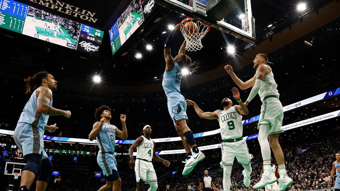 Ja Morant completes a spectacular reverse slam amid Celtics defenders in the second half of the Grizzlies' victory over the Celtics Saturday at TD Garden. 