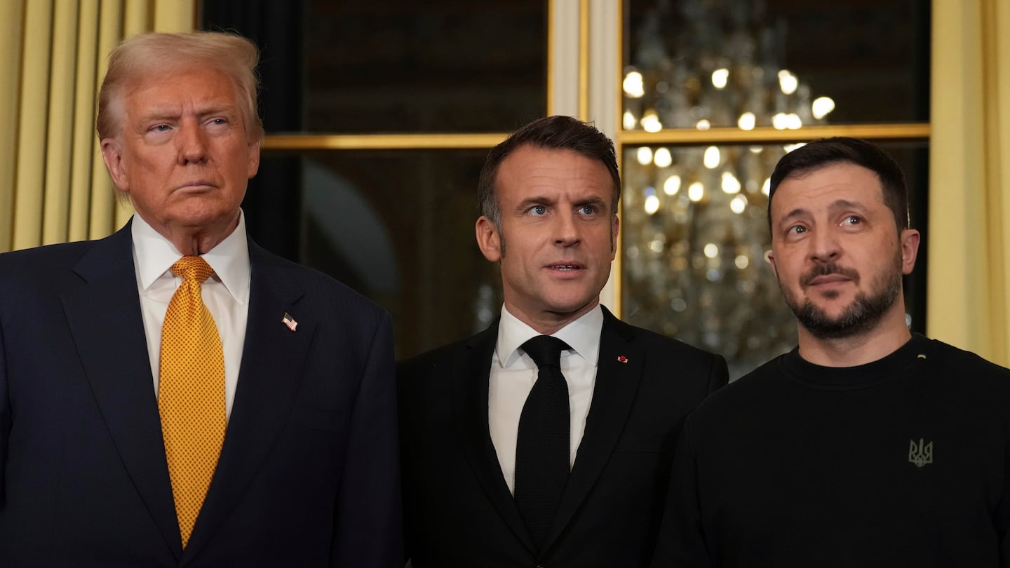 French President Emmanuel Macron, center, poses with President-elect Donald Trump, left, and Ukraine's President Volodymyr Zelenskyy at the Elysee Palace, Saturday, Dec. 7 in Paris.