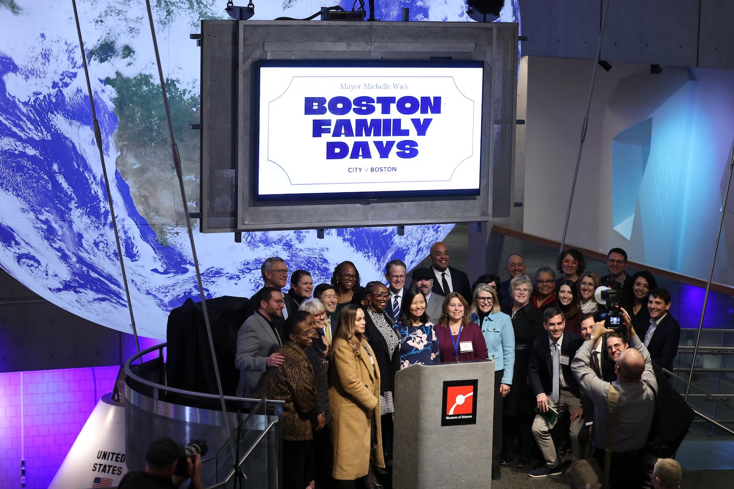 Mayor Michelle Wu joined school leaders and representatives from Boston's cultural institutions for a group photo after announcing Boston Family Days, an expansion of the BPS Sundays pilot program that allowed free access to museums and zoos for Boston's students and their families at the Museum of Science.