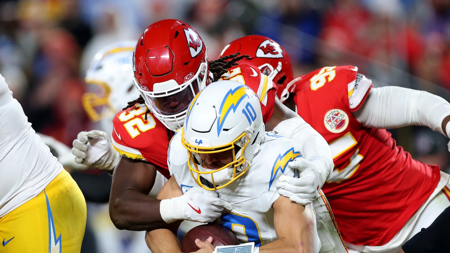 Chargers quarterback Justin Herbert briefly needed to leave Sunday's game after being taken down by Kansas City's Nick Bolton (32), but returned to stage a comeback that had Los Angeles ahead until the final second.