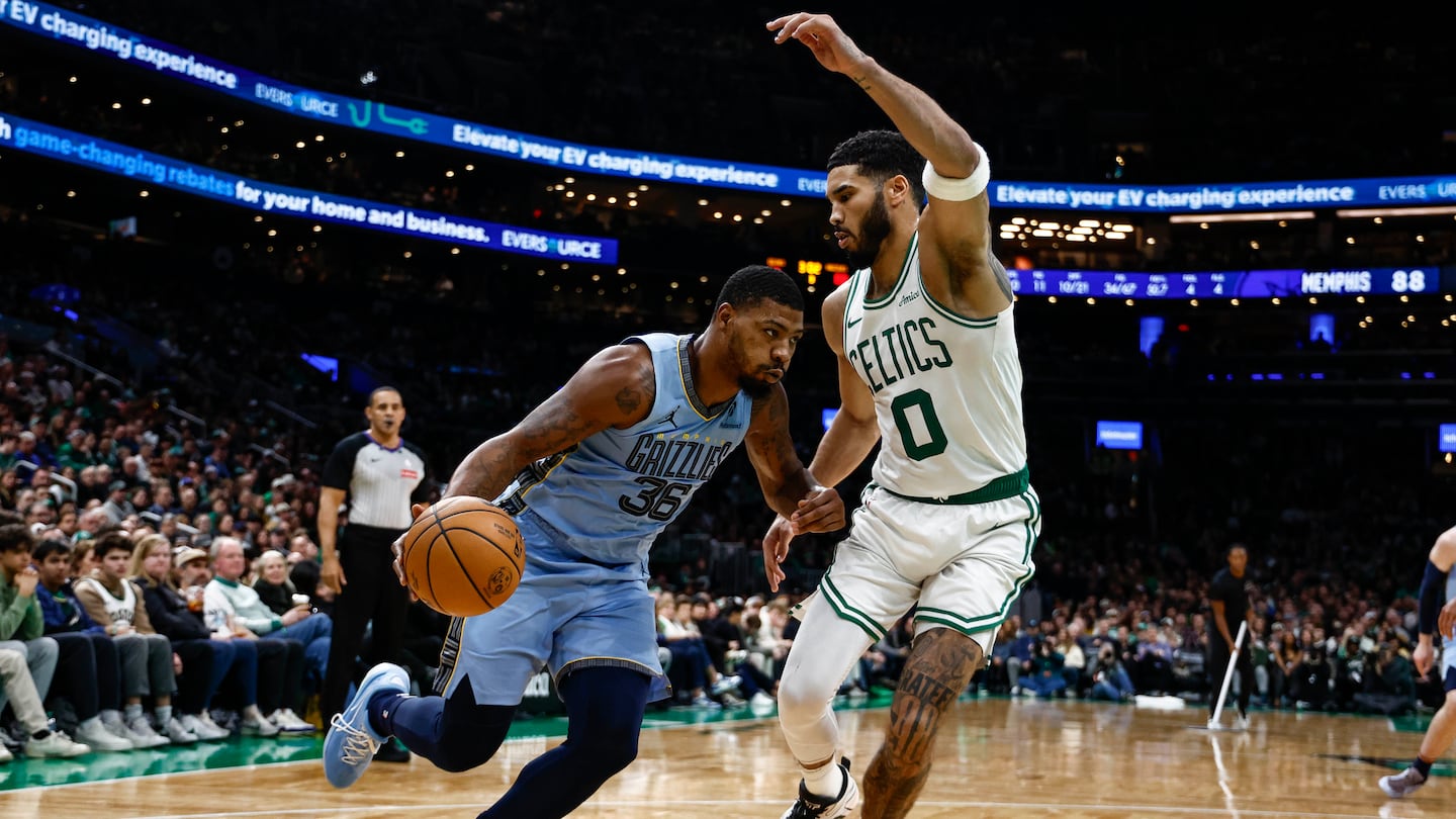 Marcus Smart, playing his first game in Boston as an opponent, drove on former teammate Jayson Tatum.