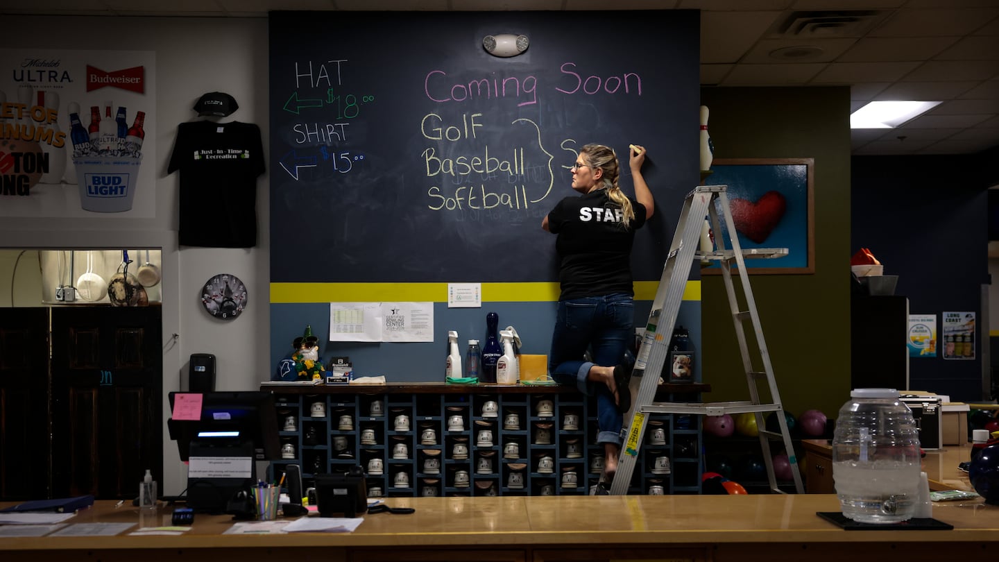 Owner Samantha Juray added a  promotion to a blackboard at the front desk at Just-In-Time Recreation in Lewiston, Maine on Oct. 2. The bowling alley was devastated on Oct. 25, 2023, the night of the state’s deadliest mass shooting that claimed 18 lives at the Just-In-Time and Schemengees Bar & Grille.