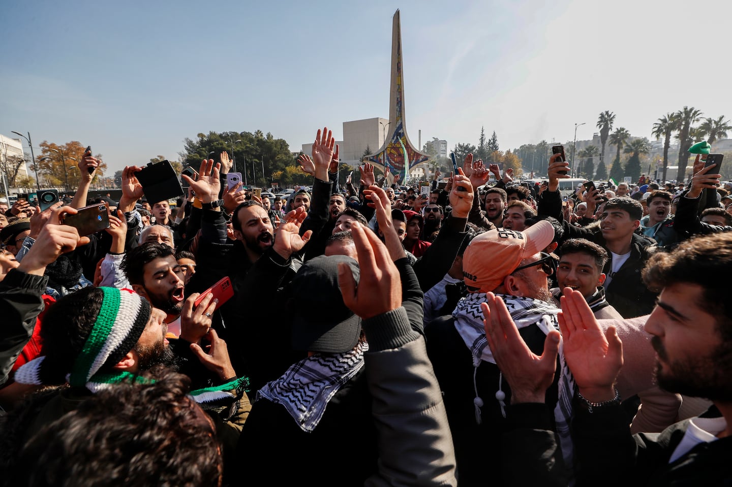 Syrians celebrate at Umayyad Square in Aleppo, Syria, Monday, Dec. 9, 2024.