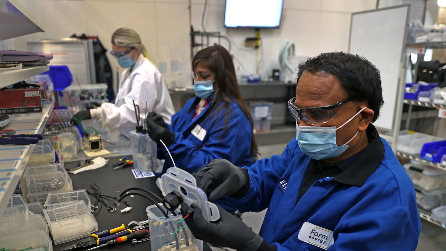 Technicians working at Form Energy in Somerville, a company that makes utility-scale batteries.