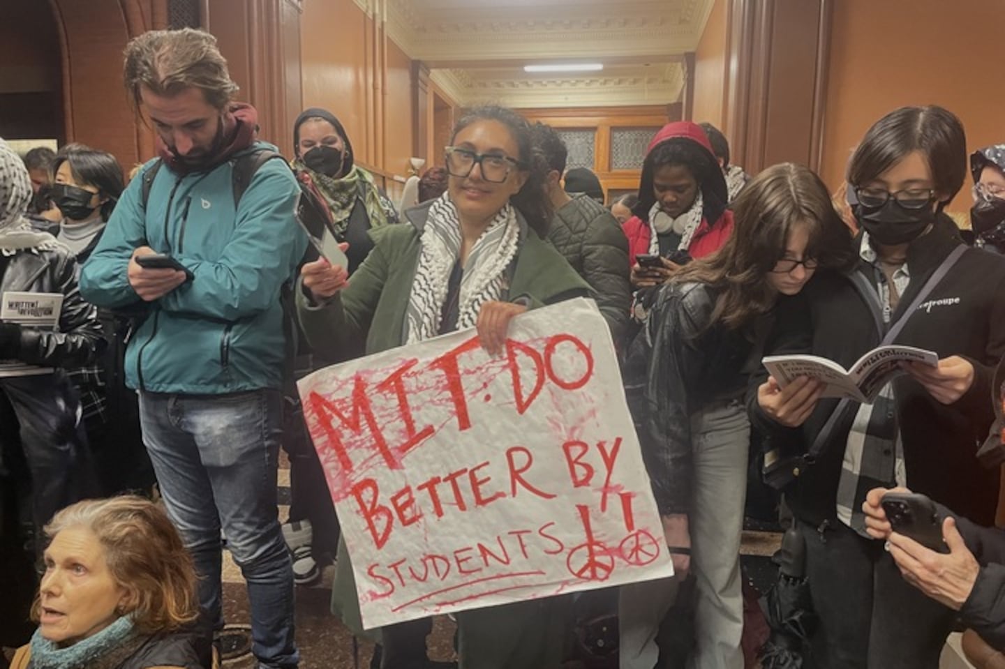 Students stood in the foyer of Cambridge City Hall during Monday night's City Council meeting.