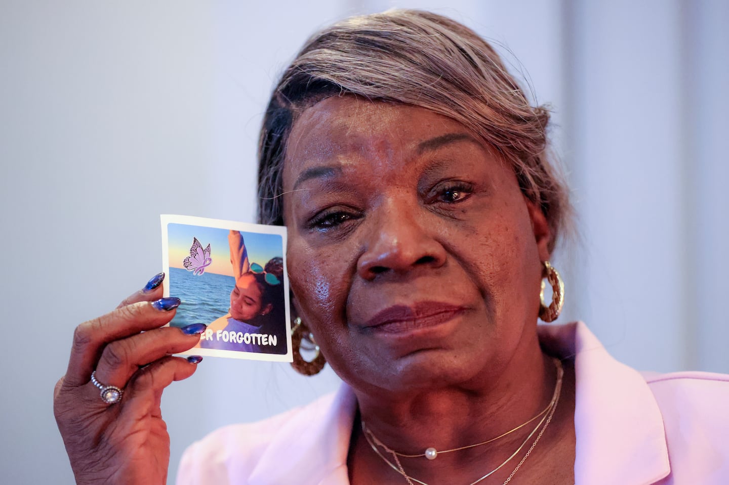 Providence City Councilor Mary Kay Harris holds a photo of her granddaughter, Emoni Chaney, from their final beach day together. Chaney overdosed on fentanyl in March.