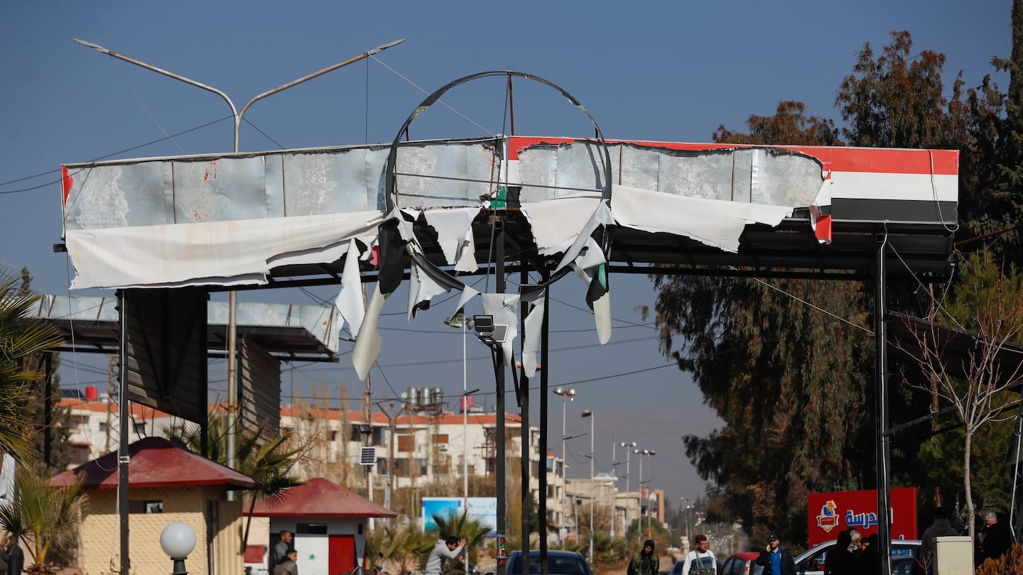 Syrian opposition fighters man a checkpoint in Damascus, Syria, on Dec. 9.