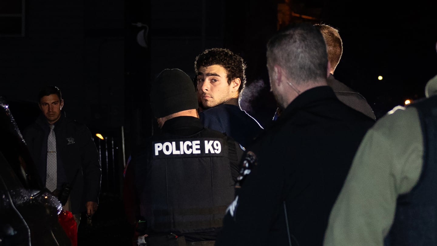 Luigi Mangione is escorted by police to his arraignment at the Blair County Courthouse in Hollidaysburg, Pa., on Dec. 9.