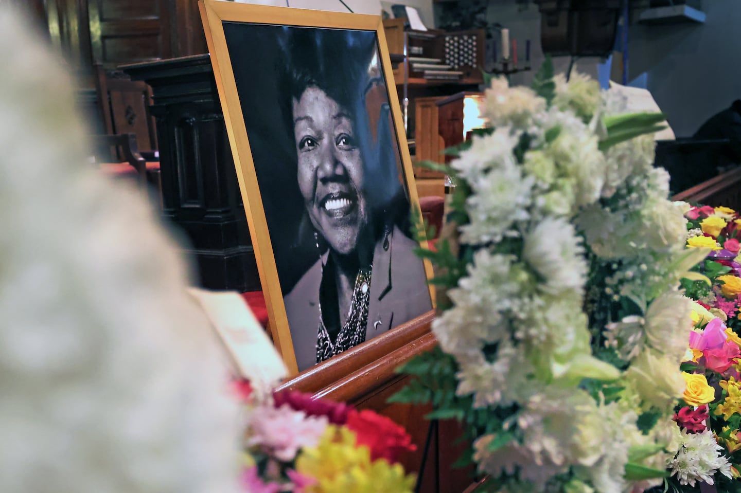 A portrait and flowers at the front of the church for long-serving Massachusetts state Representative Gloria L. Fox, who passed away on Nov. 11.