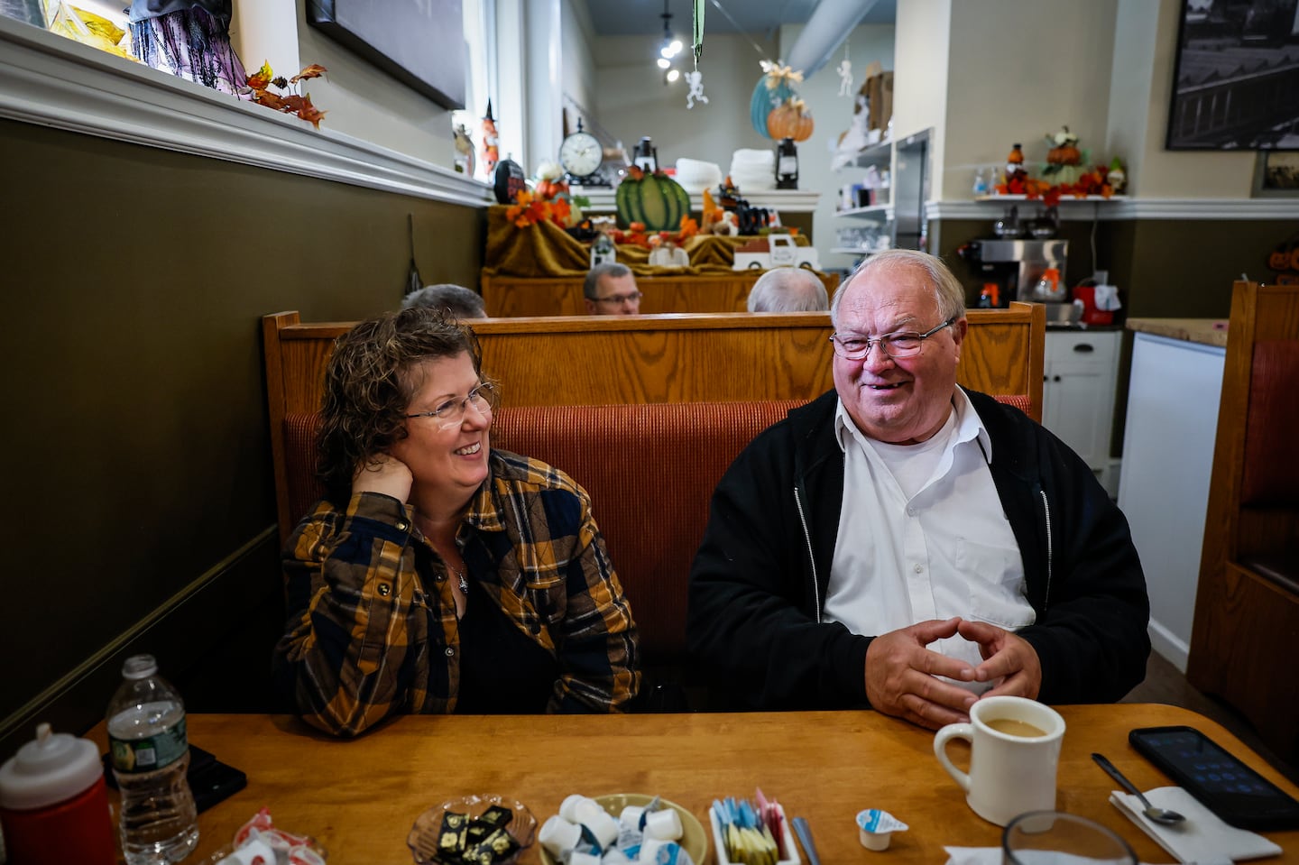 Kathy Lebel and Leroy Walker sat together at the Station Grill Restaurant, one of two restaurants Lebel now owns in Lewiston, Maine. Lebel formerly owned Schemengees Bar and Grille, where Walker's son Joseph was working when he was killed in the 2023 mass shooting that claimed 18 lives. One year later, Lebel purchased a new restaurant, to mark a new beginning.