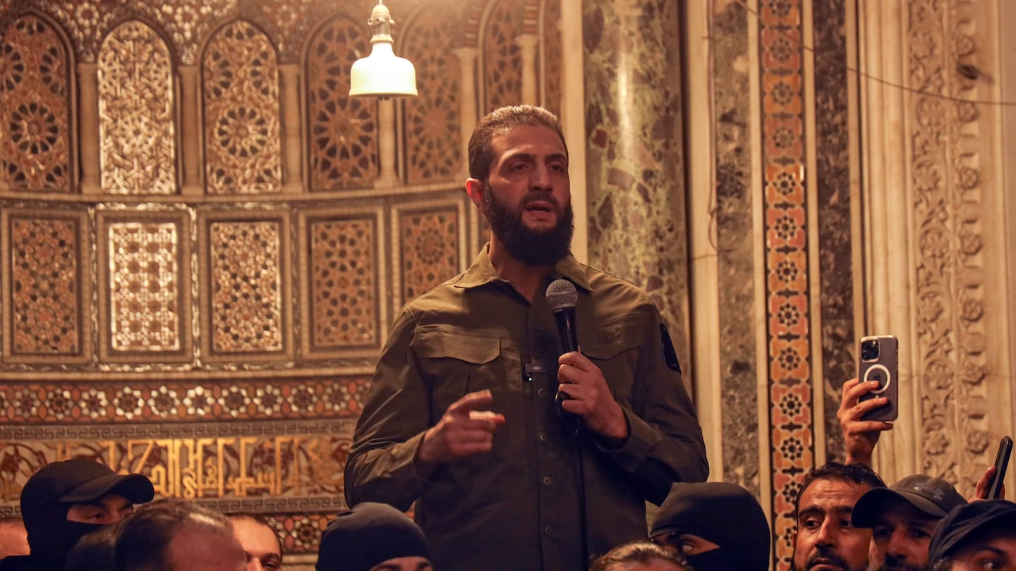 Abu Mohammed al-Golani speaks at the Umayyad Mosque in Damascus on Dec. 8.