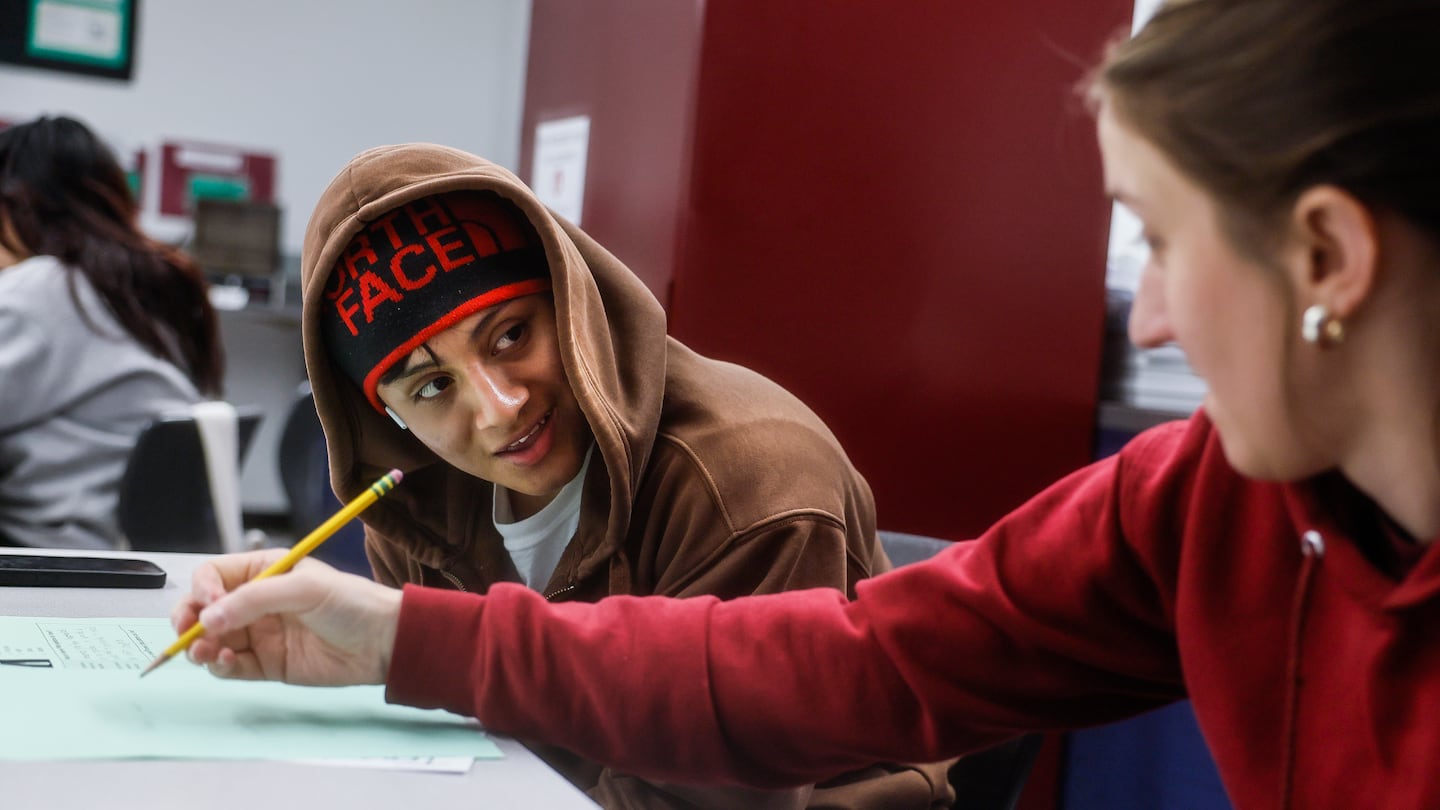 Science teacher Jamie Kendall provided one-on-one guidance to Rudy, 17, during class at Chelsea Opportunity Academy in Chelsea.