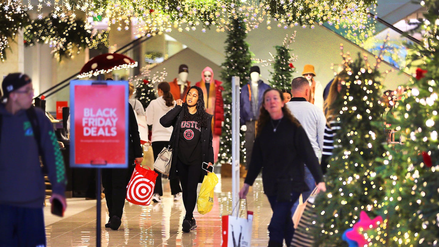 Shoppers walk through a Nordstrom store in the South Shore Plaza on Nov. 29.