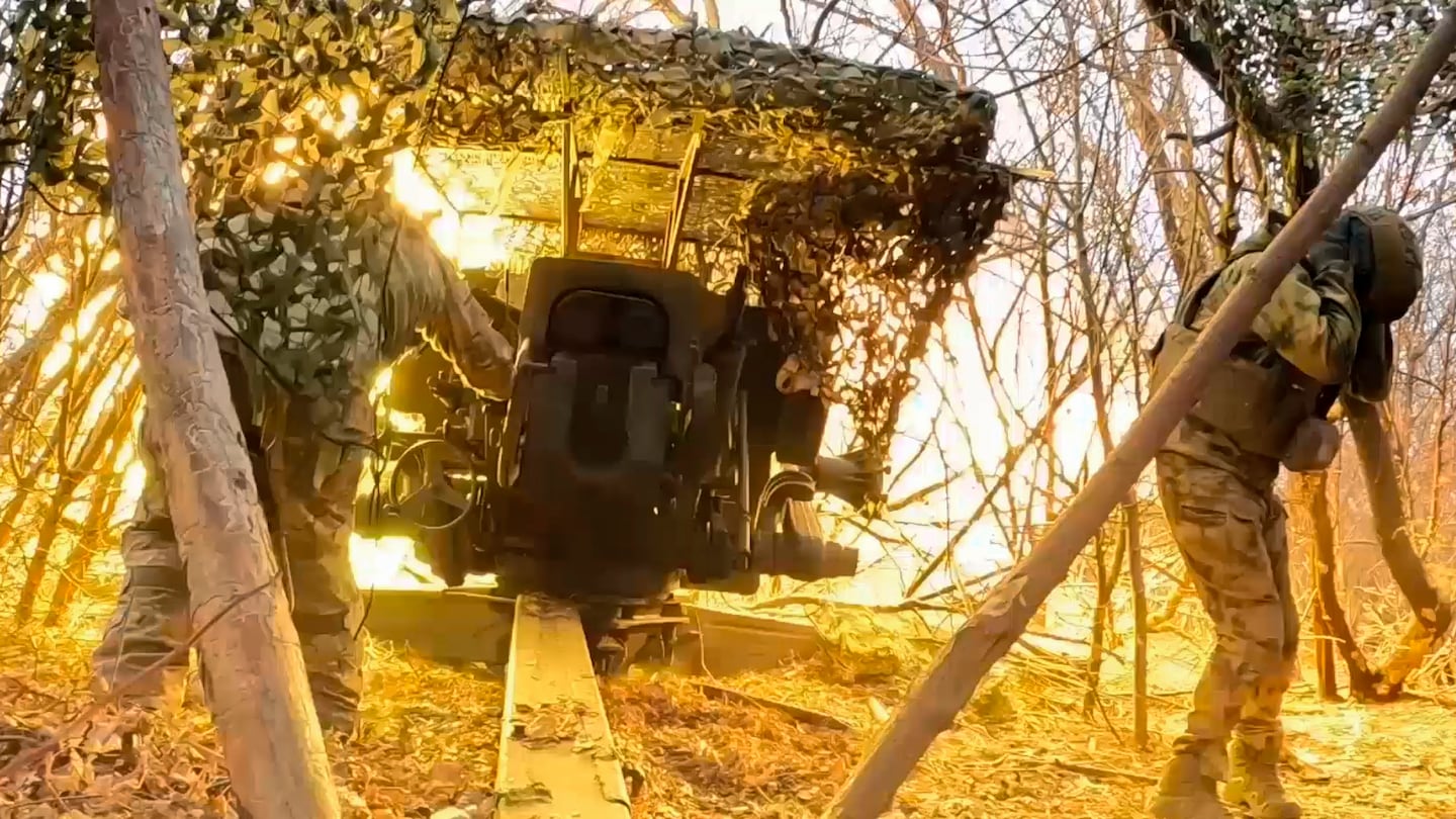 Russian servicemen fire a D-20 howitzer towards Ukrainian positions in an undisclosed location.