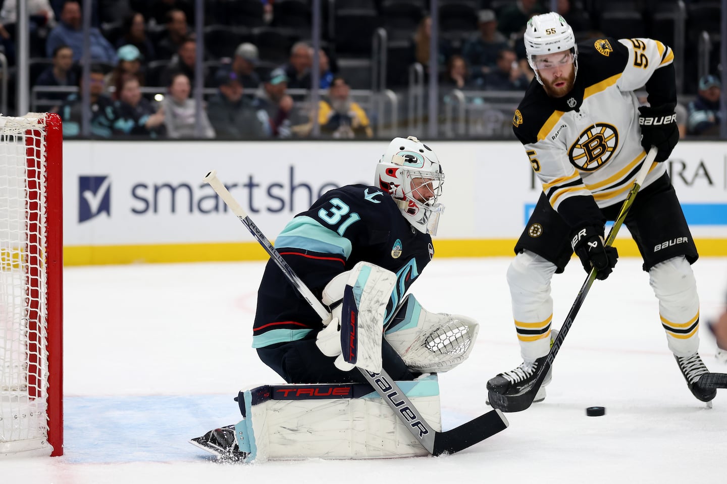 Kraken netminder Philipp Grubauer makes one of his 33 stops in front of Bruins winger Justin Brazeau during Seattle's 5-1 win Thursday night. 