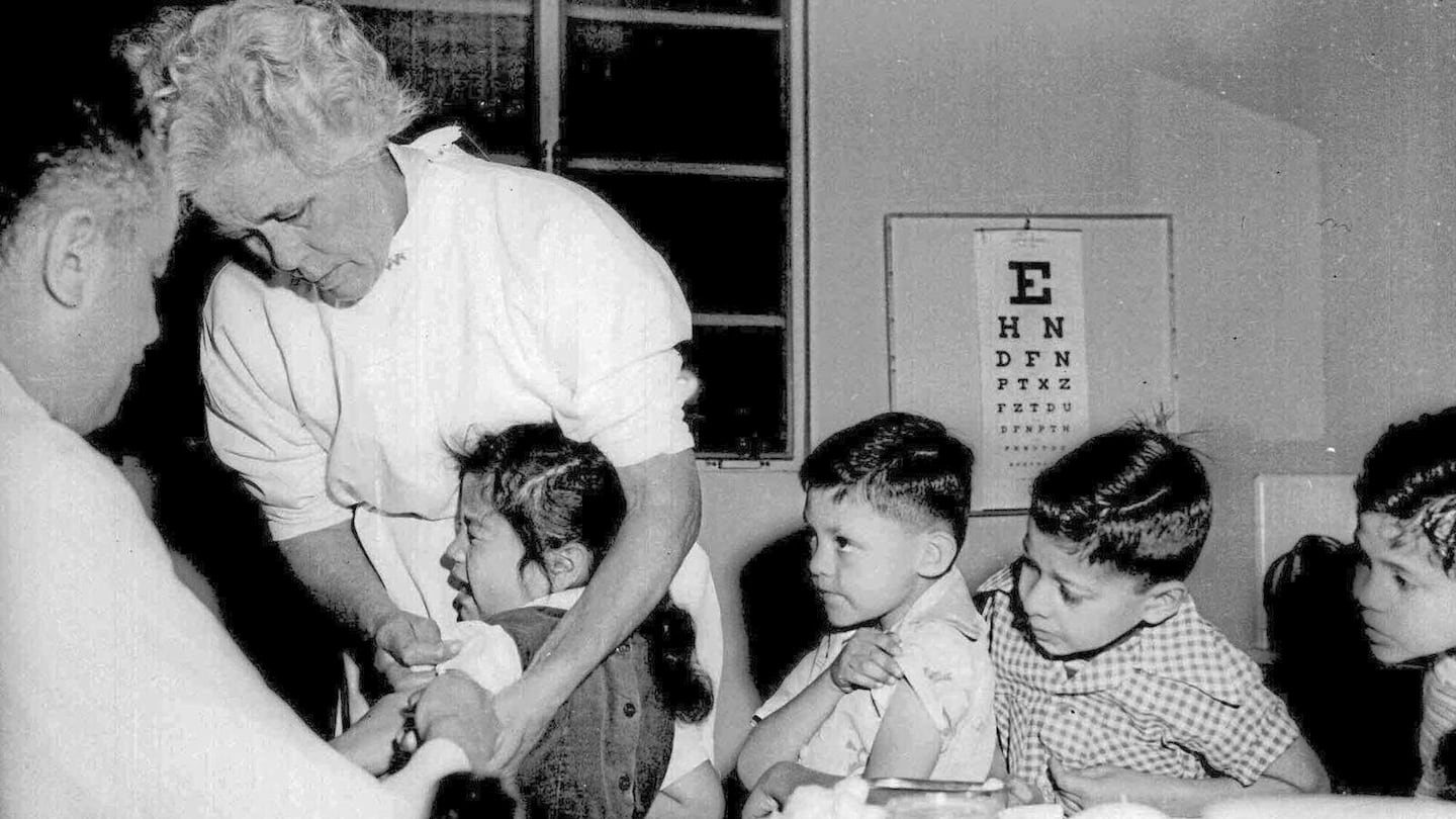 In this April 1955 file photo, first and second-graders at St. Vibiana's school are inoculated against polio with the Salk vaccine in Los Angeles.