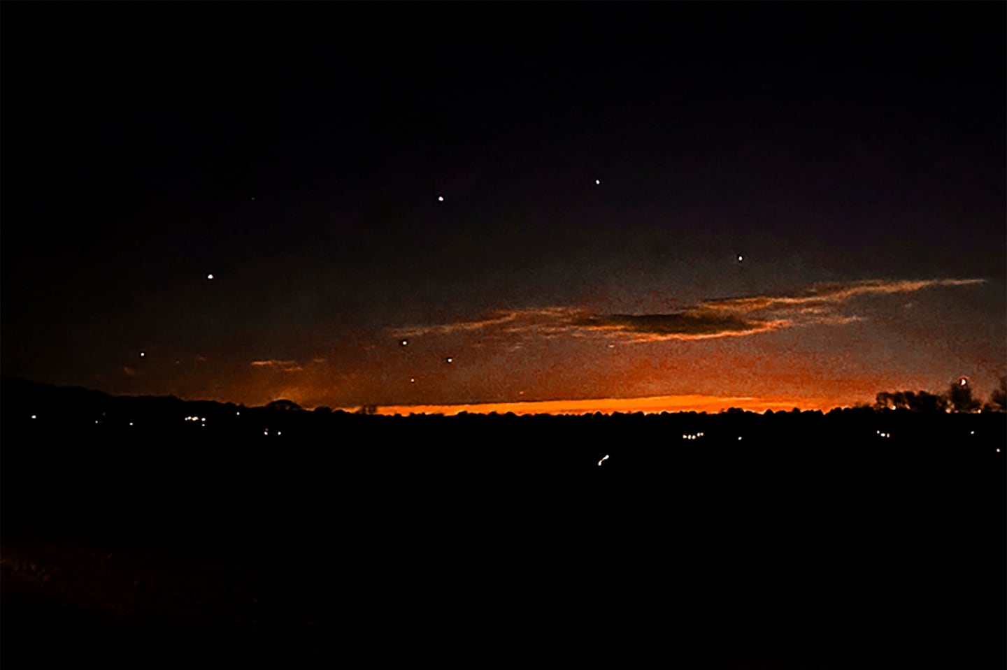 This photo provided by Trisha Bushey shows the evening sky and points of light near in Lebanon Township, N.J.