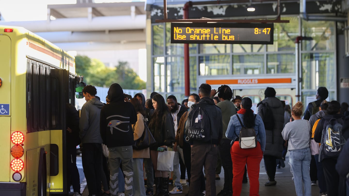 Commuters board a bus at Ruggles Station on Oct. 8, 2024.