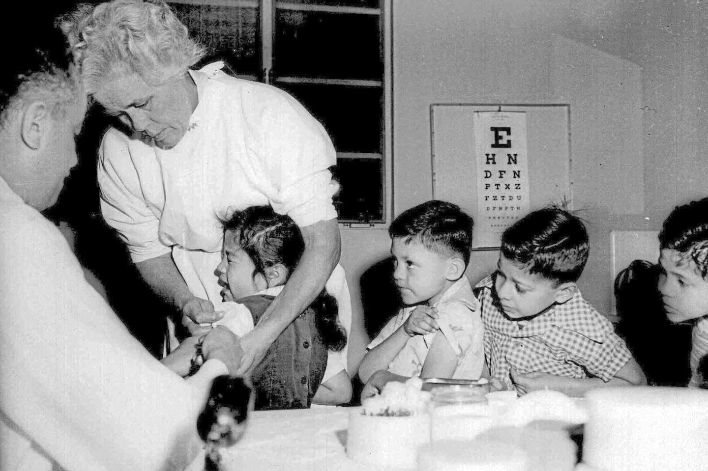 In this April 1955 file photo, first and second-graders at St. Vibiana's school are inoculated against polio with the Salk vaccine in Los Angeles.